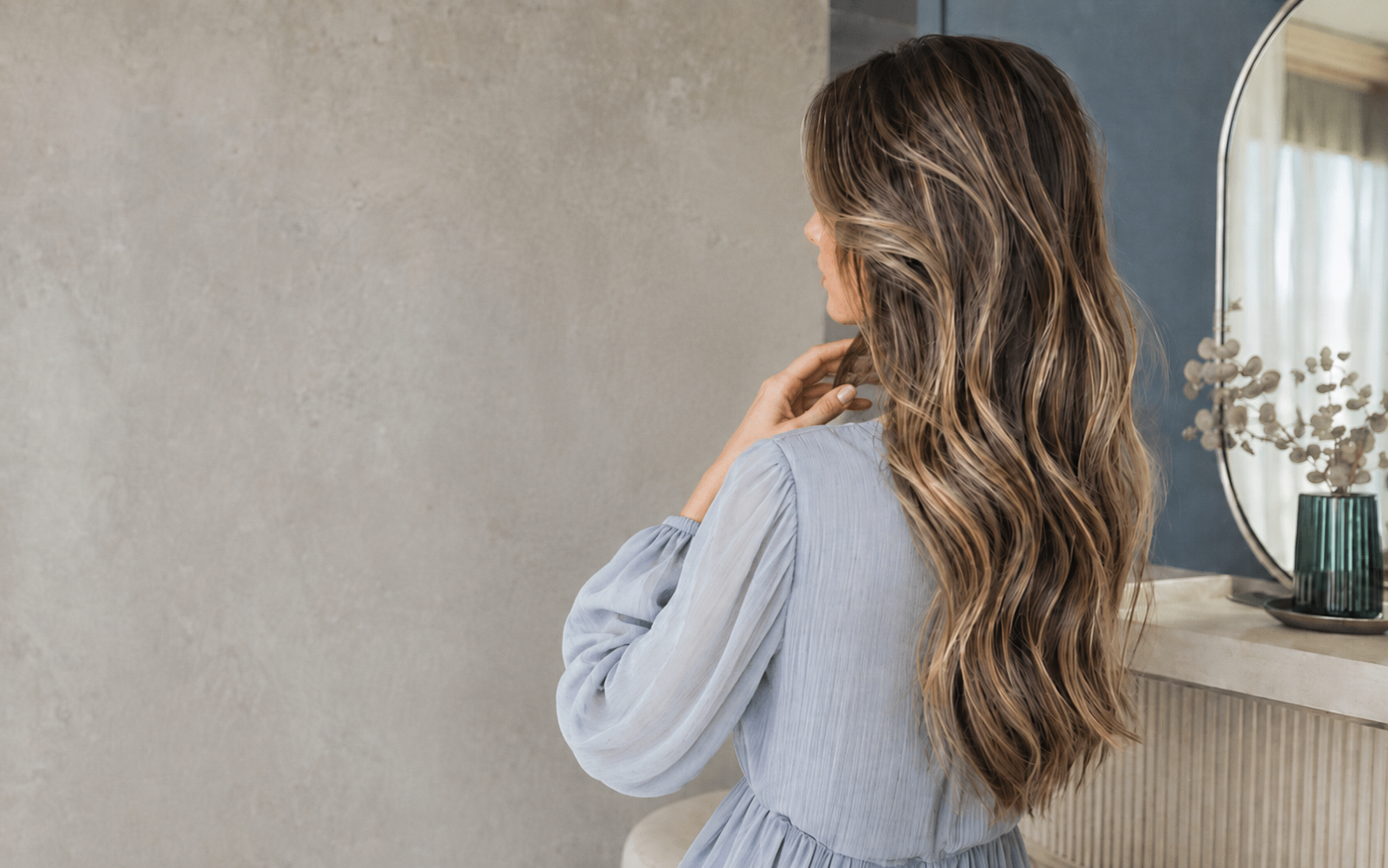 Young Caucasian woman comparing highlighted balayage and rooted Remy hair extensions